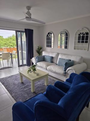 White double couch and blue standalone chairs